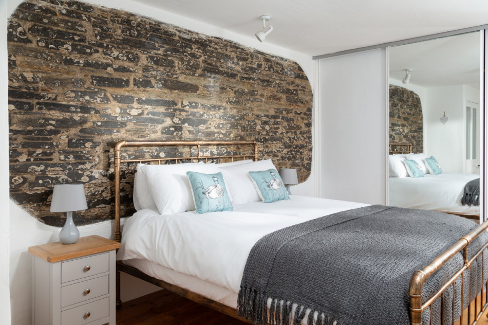 Waverly Cottage bedroom with feature stone wall