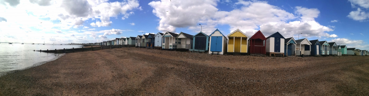 Beach huts beneath a blue sky at Southend